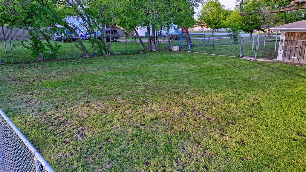 522 Montague Street Nocona, TX 76255 - Photo 21 of 25 a view of a backyard with a garden