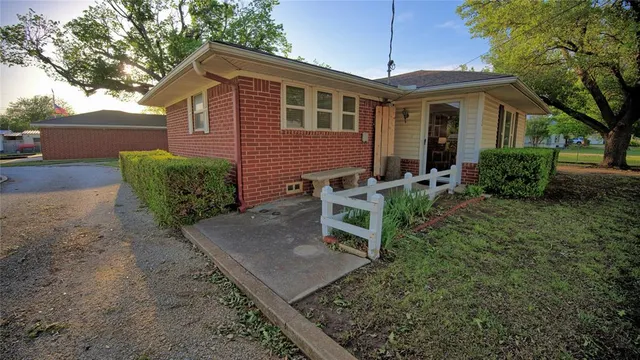 a backyard of a house with yard and outdoor seating