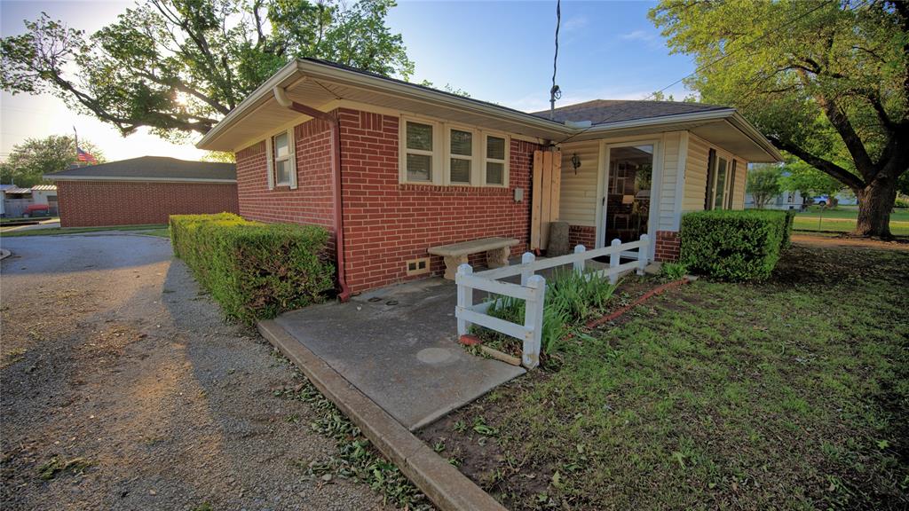 522 Montague Street Nocona, TX 76255 - Photo 22 of 25 a backyard of a house with yard and outdoor seating