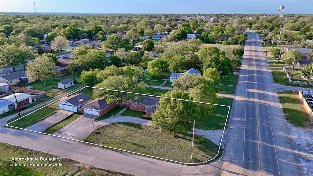 522 Montague Street Nocona, TX 76255 - Photo 24 of 25 a view of a yard with potted plants