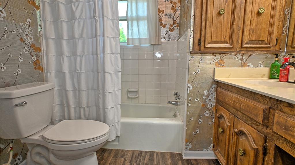 522 Montague Street Nocona, TX 76255 - Photo 7 of 25 a bathroom with a sink a toilet and shower