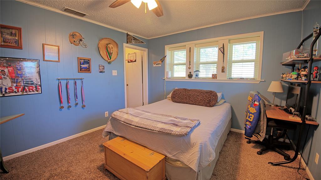 522 Montague Street Nocona, TX 76255 - Photo 8 of 25 a bedroom with a bed and a desk