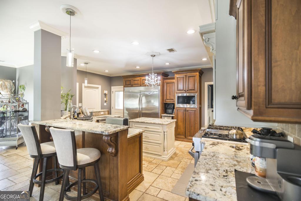 4065 Gordon Road Abbeville, GA 31001 - Photo 12 of 48 a dining hall with stainless steel appliances kitchen island granite countertop a dining table and chairs