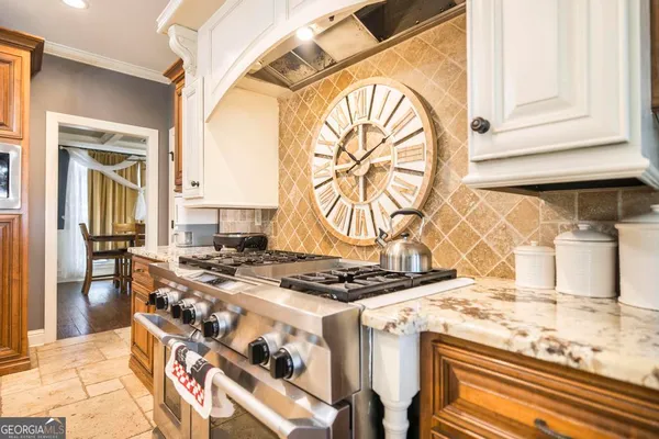 a kitchen with a stove and a white refrigerator
