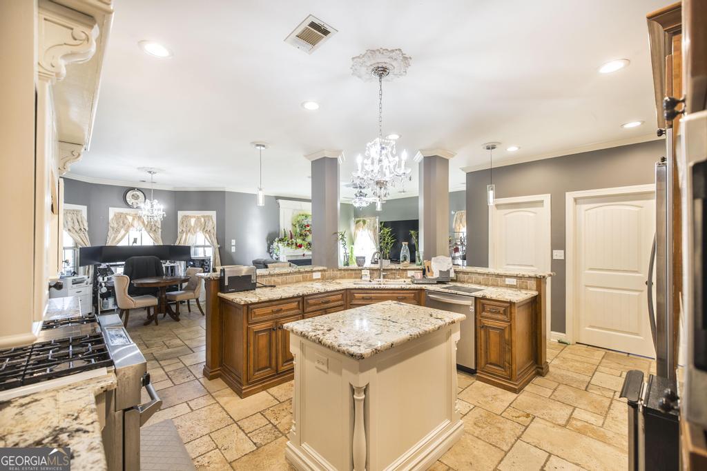 4065 Gordon Road Abbeville, GA 31001 - Photo 16 of 48 a kitchen with kitchen island a stove a sink a counter top space and living room view