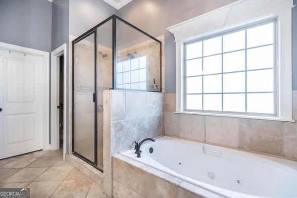a bathroom with a tub shower and sink