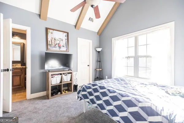 a bedroom with a bed and a window