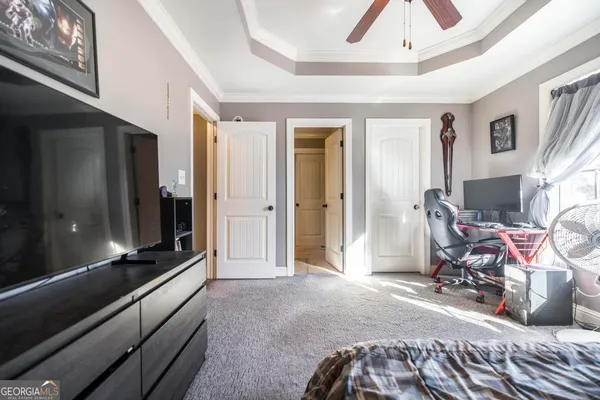 a bedroom with furniture and a flat screen tv