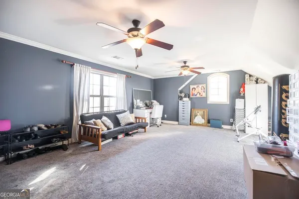 a living room with furniture a chandelier and a window