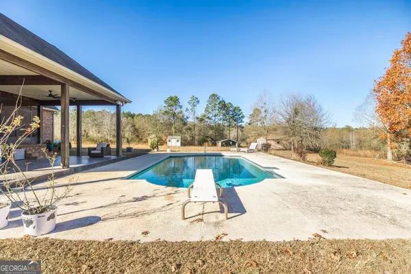 a view of a swimming pool with an outdoor seating