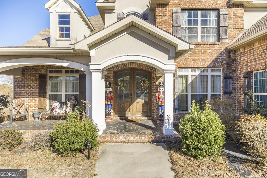 4065 Gordon Road Abbeville, GA 31001 - Photo 4 of 48 a view of a white house with large windows