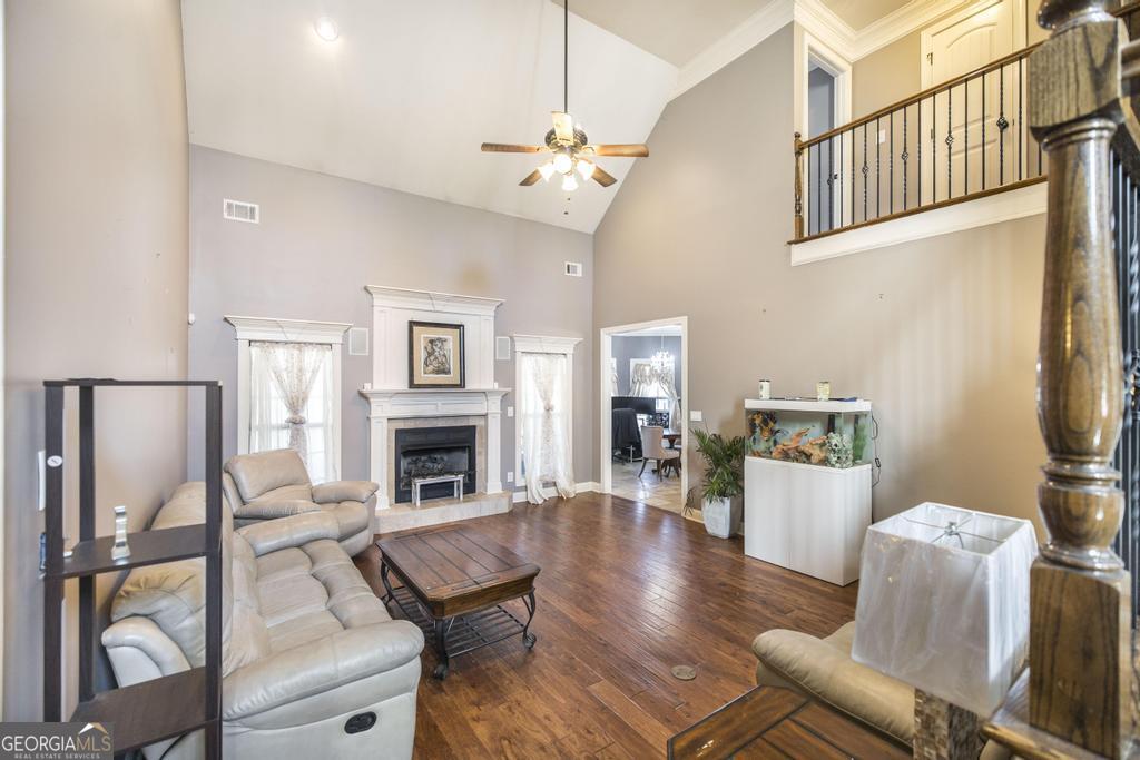 4065 Gordon Road Abbeville, GA 31001 - Photo 8 of 48 a living room with furniture a fireplace and a chandelier