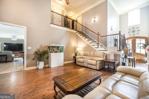 a living room with furniture and wooden floor