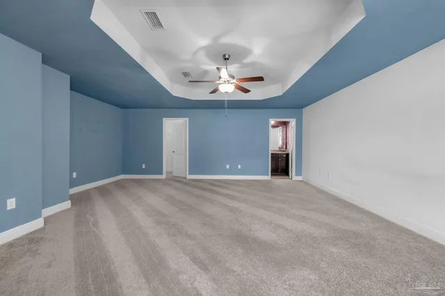 a view of an empty room with a ceiling fan
