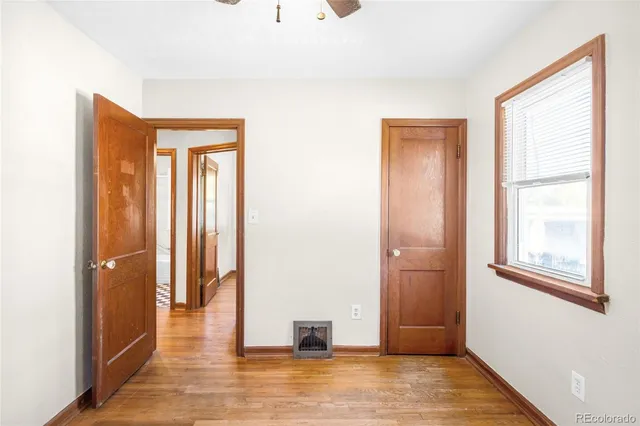 a view of a room with wooden floor and windows