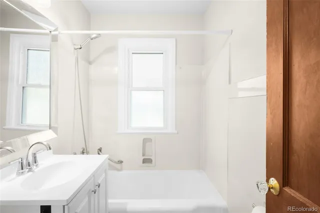 a white bath tub sitting next to a white sink