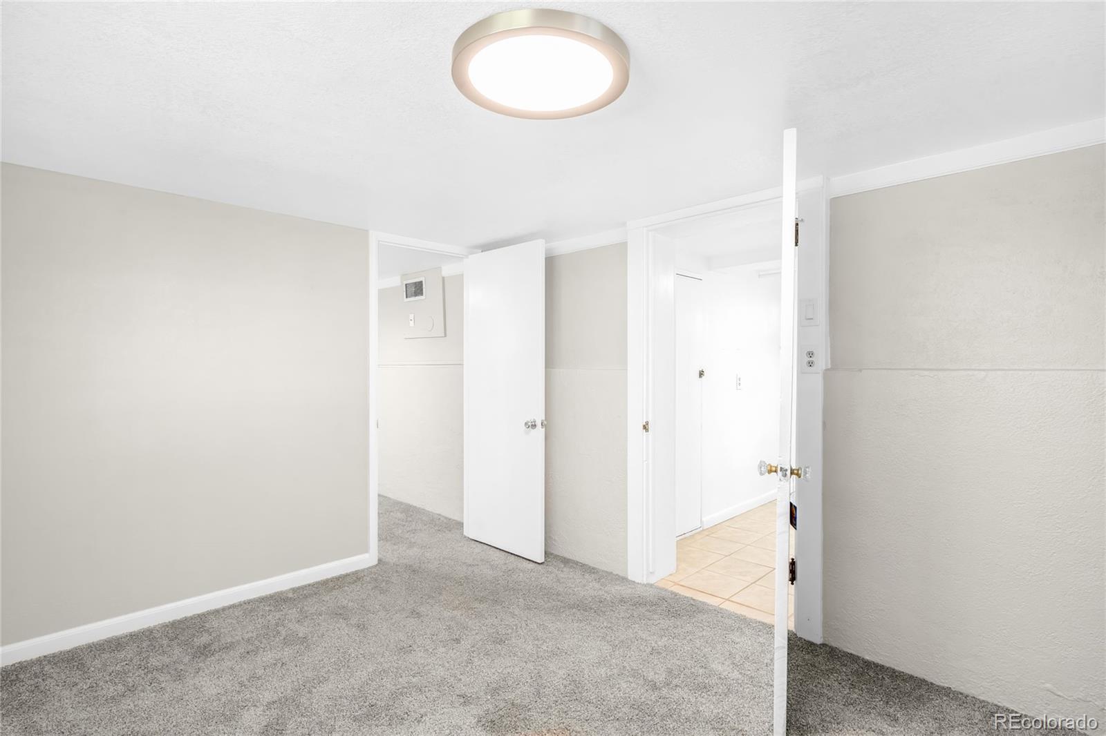 3535 High Court Wheat Ridge, CO 80033 - Photo 19 of 26 an empty room with wooden floor and windows