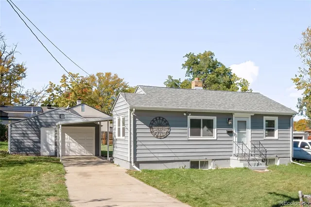 a front view of a house with a garden and yard