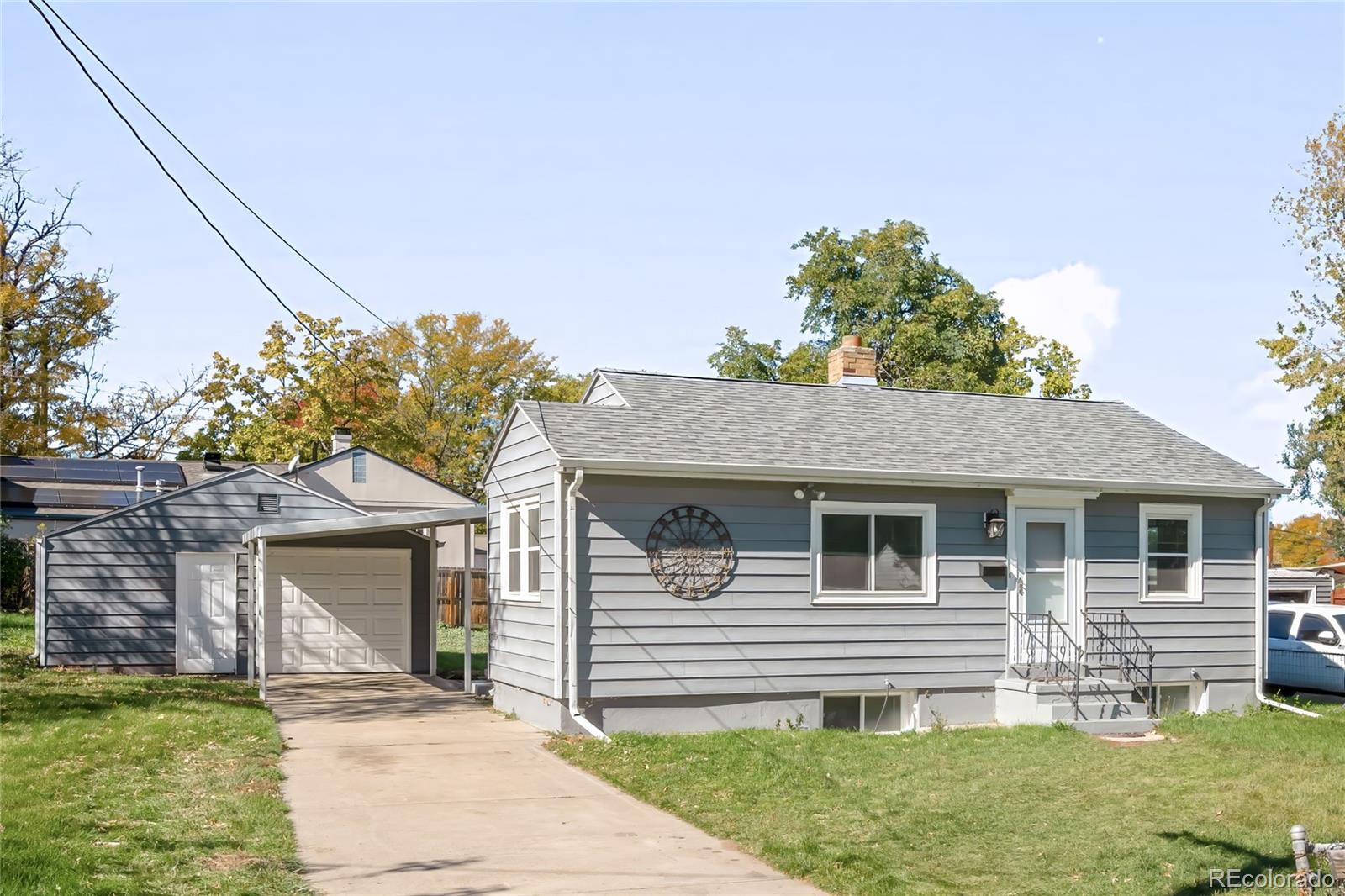3535 High Court Wheat Ridge, CO 80033 - Photo 2 of 26 a front view of a house with a garden and yard