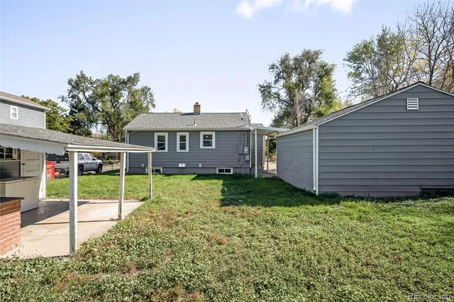 a view of a house with a backyard and a patio