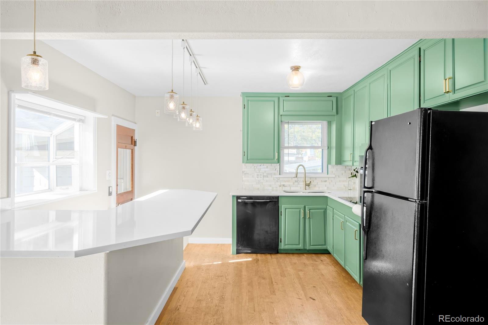 3535 High Court Wheat Ridge, CO 80033 - Photo 5 of 26 a kitchen with kitchen island a refrigerator stove and sink