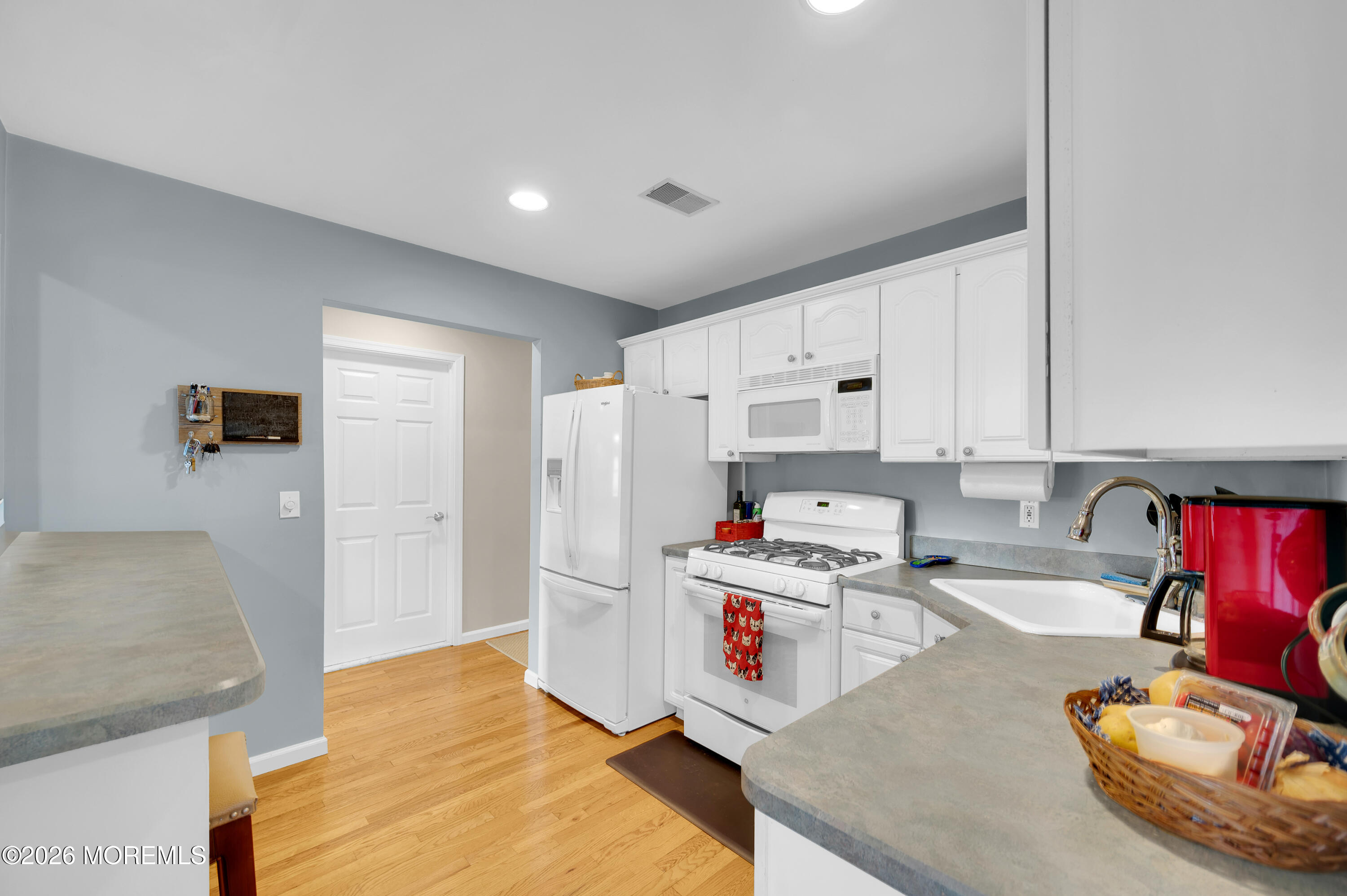 317 Carter Avenue Point Pleasant Beach, NJ 08742 - Photo 36 of 49 a kitchen with stainless steel appliances granite countertop a sink refrigerator and white cabinets