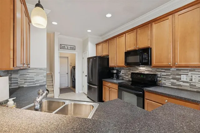 an empty room with a ceiling fan and carpet
