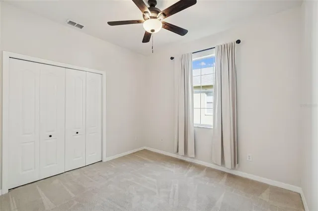 a view of a house with a yard and tree s