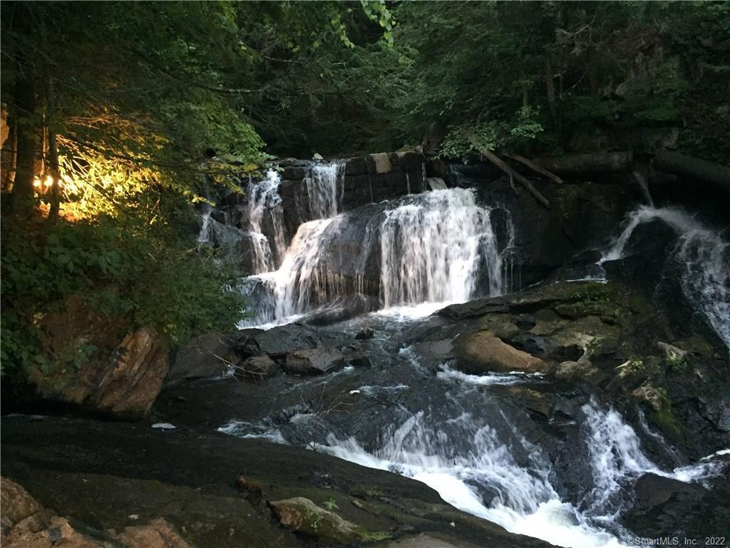Lights that turn on from inside the house light up the falls at night for a spectacular glow. Illumination and sound ~ what a combination!