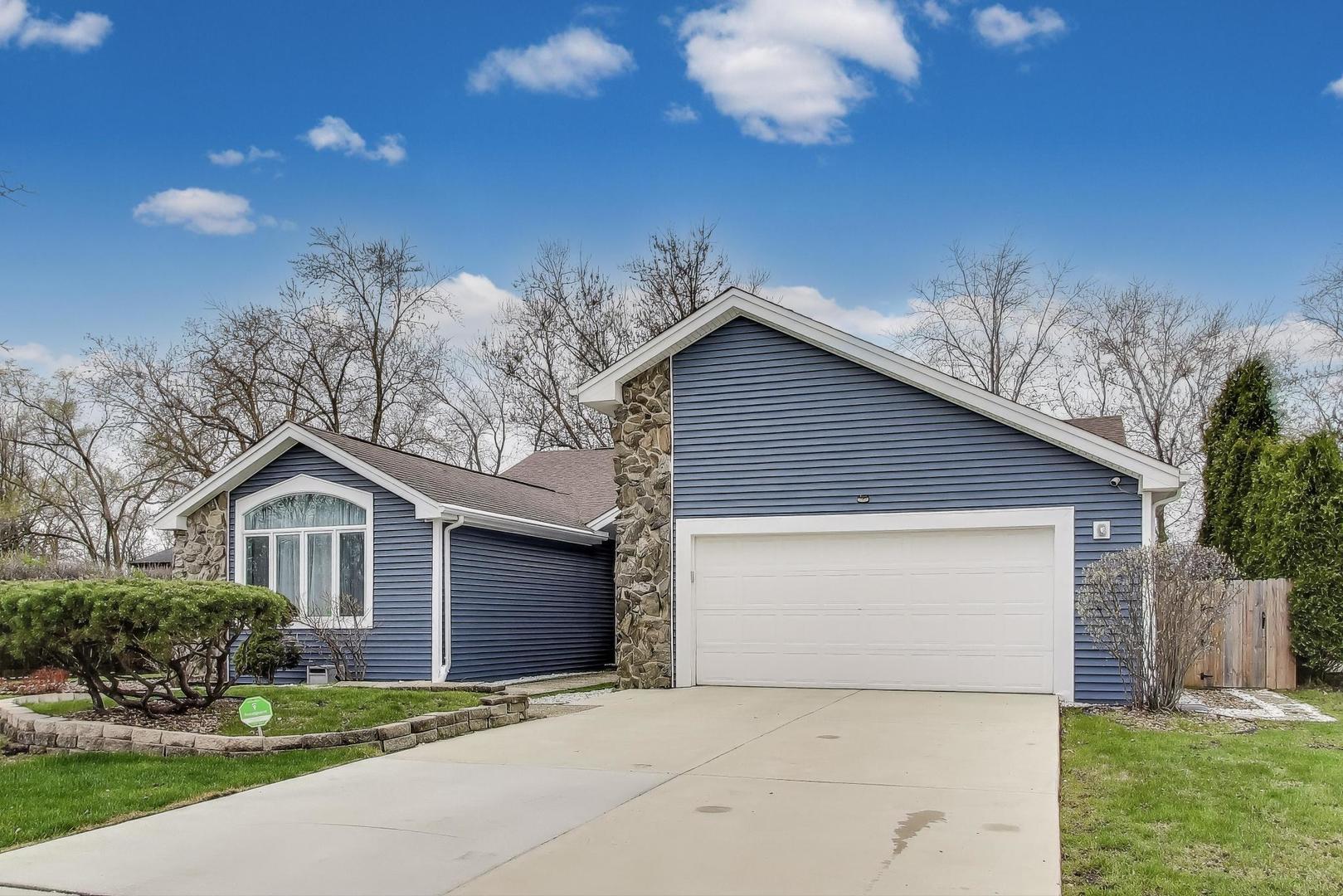 1344 Southwind Drive Northbrook, IL 60062 - Photo 2 of 39 a front view of a house with a garden and yard