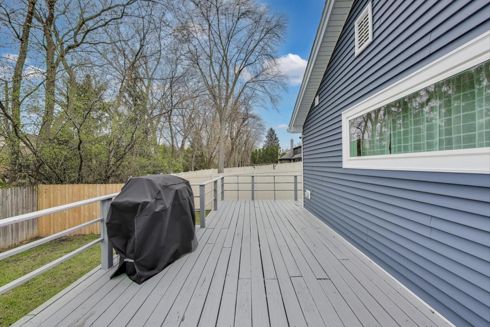 1344 Southwind Drive Northbrook, IL 60062 - Photo 31 of 39 a view of a roof deck with wooden floor and fence next to a yard