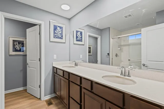 a bathroom with a double vanity sink and a mirror