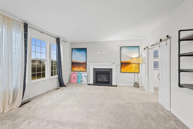 a kitchen with a table chairs refrigerator and cabinets
