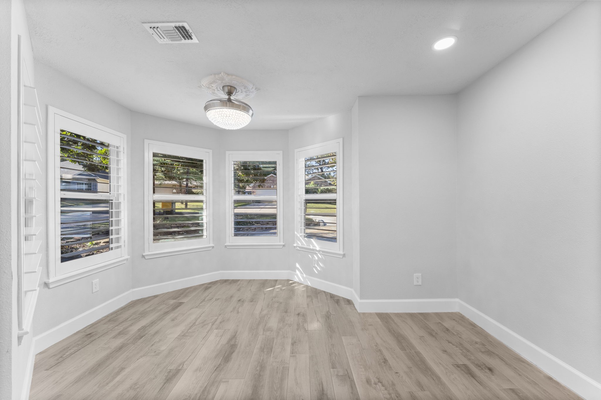 22 Shady Oak Lane Conroe, TX 77304 - Photo 16 of 44 wooden floor in an empty room with a window