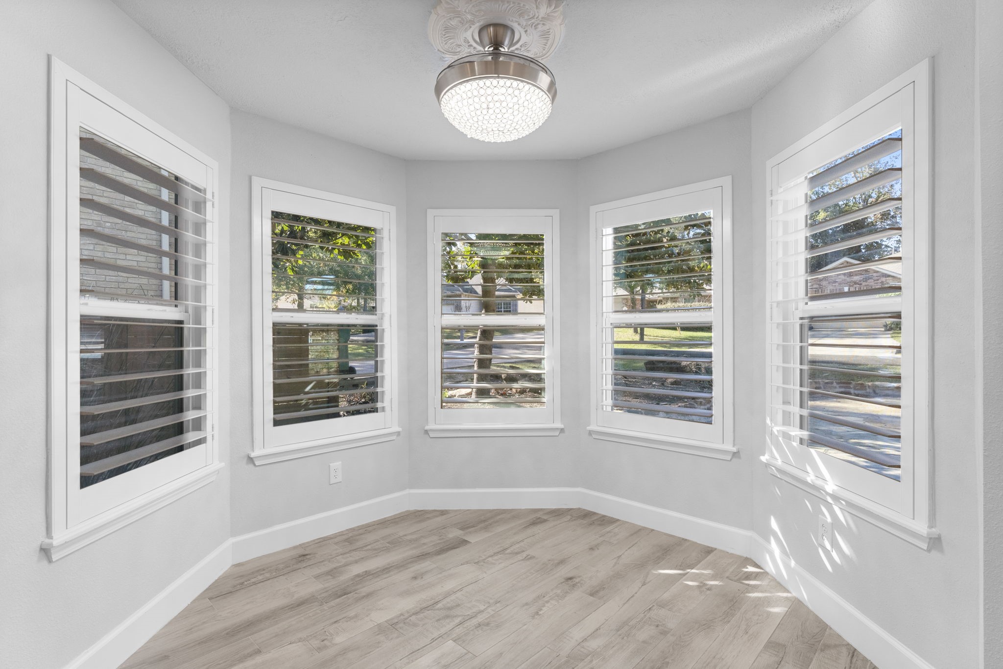 22 Shady Oak Lane Conroe, TX 77304 - Photo 17 of 44 a view of an empty room with a window and wooden floor