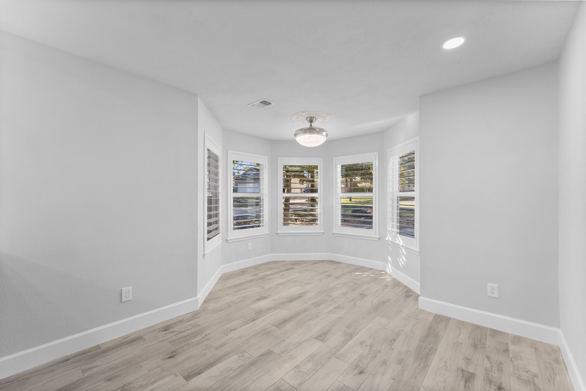 22 Shady Oak Lane Conroe, TX 77304 - Photo 18 of 44 wooden floor in an empty room with a window
