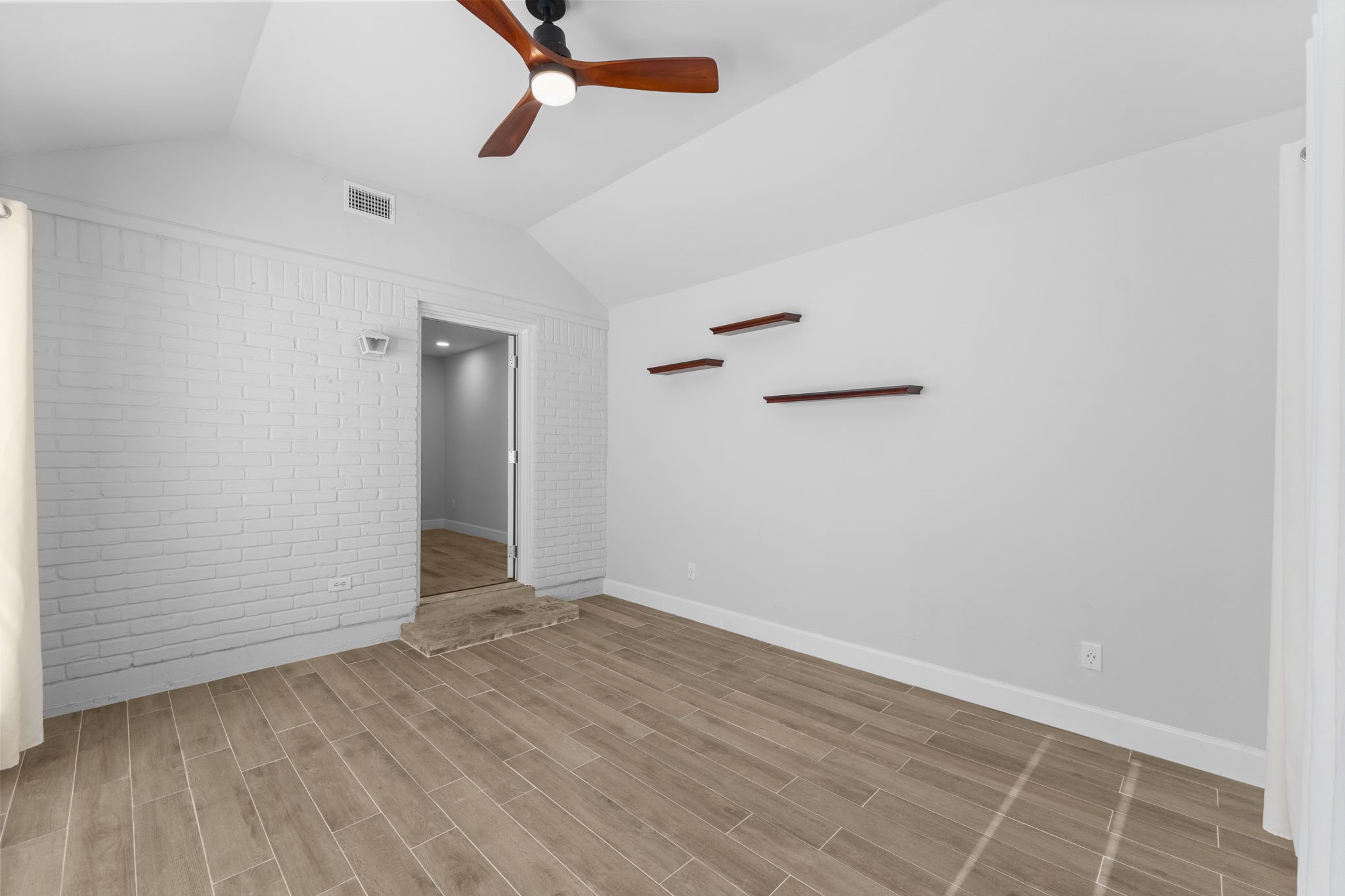 22 Shady Oak Lane Conroe, TX 77304 - Photo 32 of 44 an empty room with wooden floor cabinet and windows
