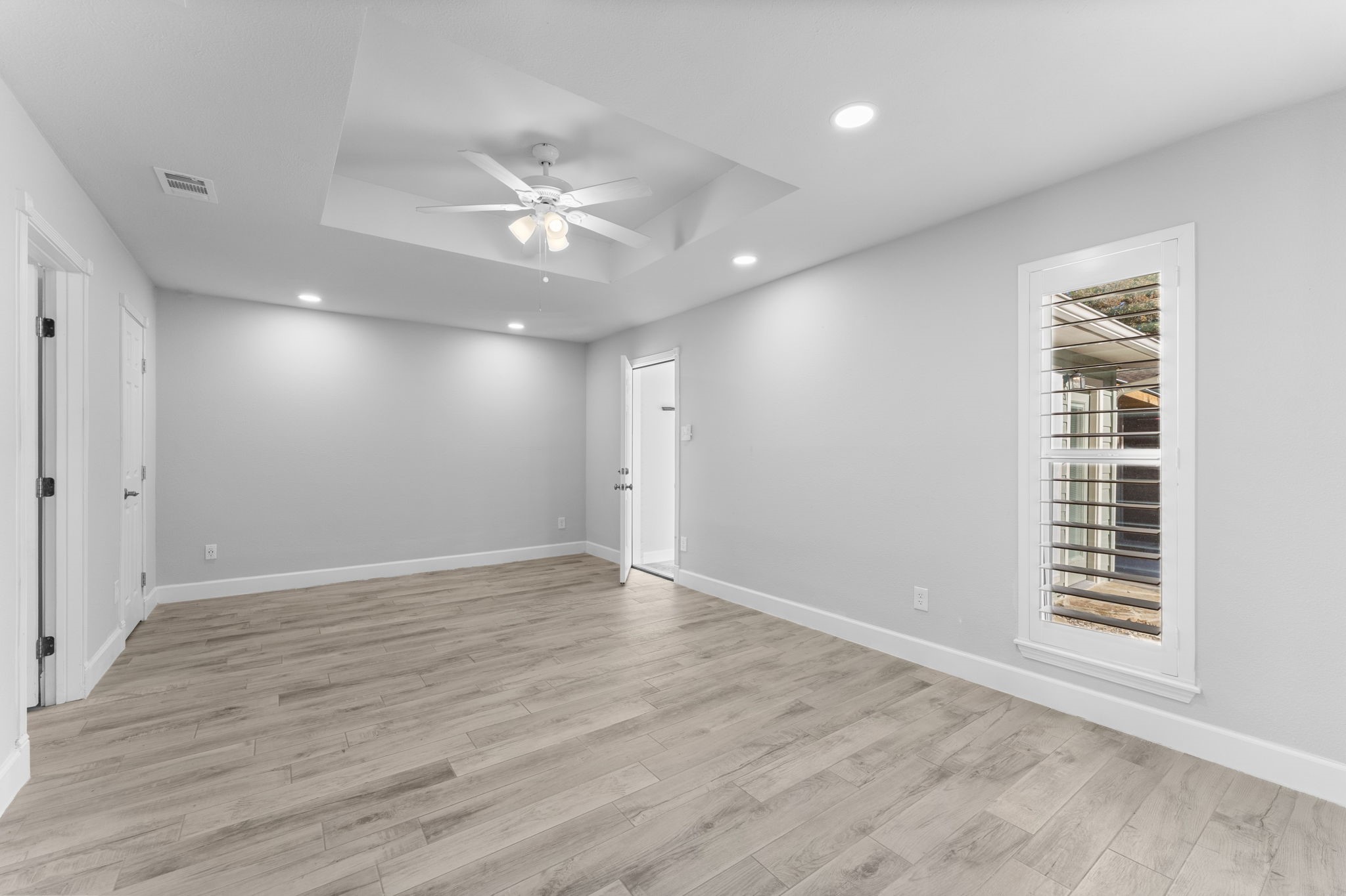 22 Shady Oak Lane Conroe, TX 77304 - Photo 33 of 44 a view of an empty room with wooden floor and a window