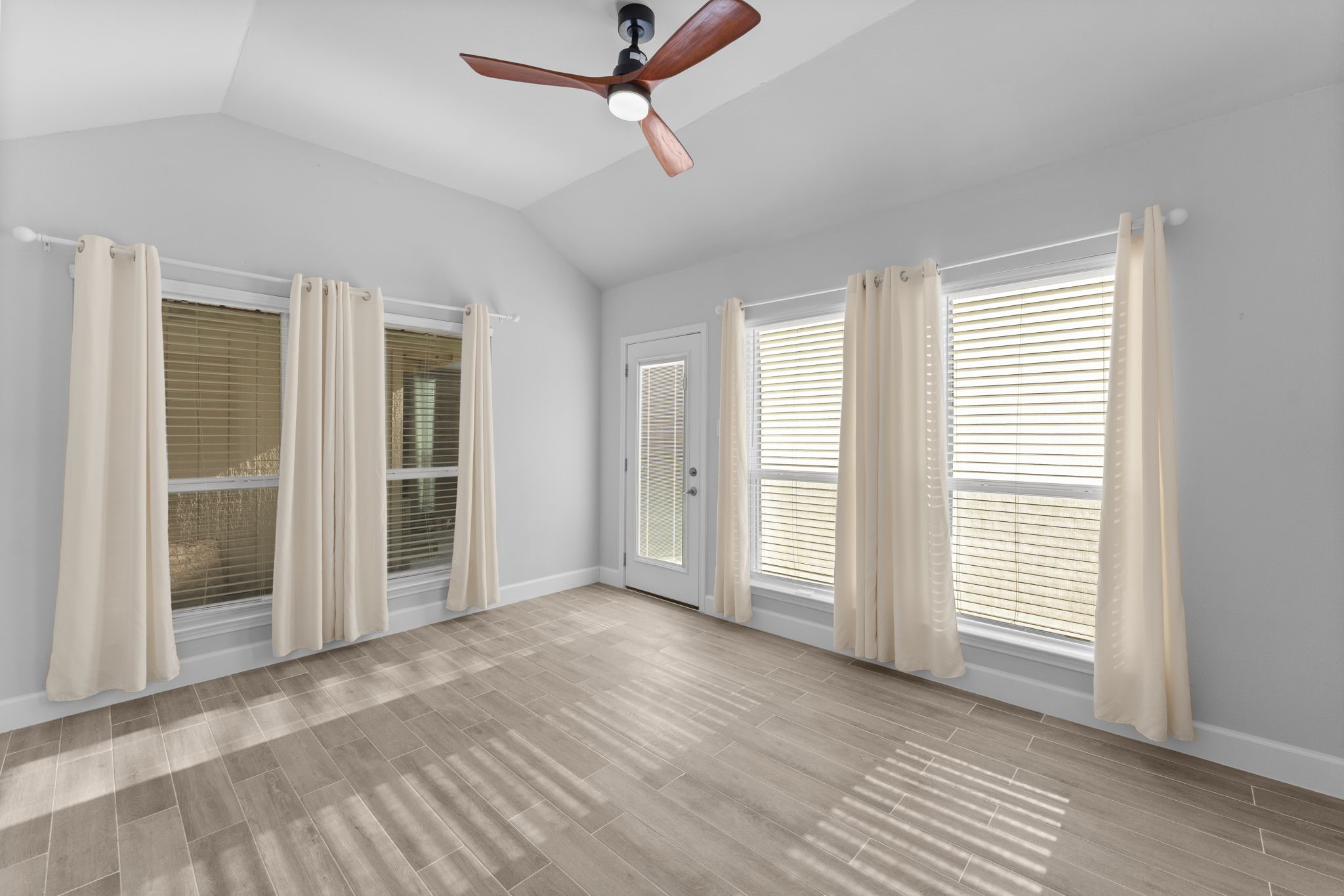 22 Shady Oak Lane Conroe, TX 77304 - Photo 34 of 44 a view of empty room with wooden floor and fan