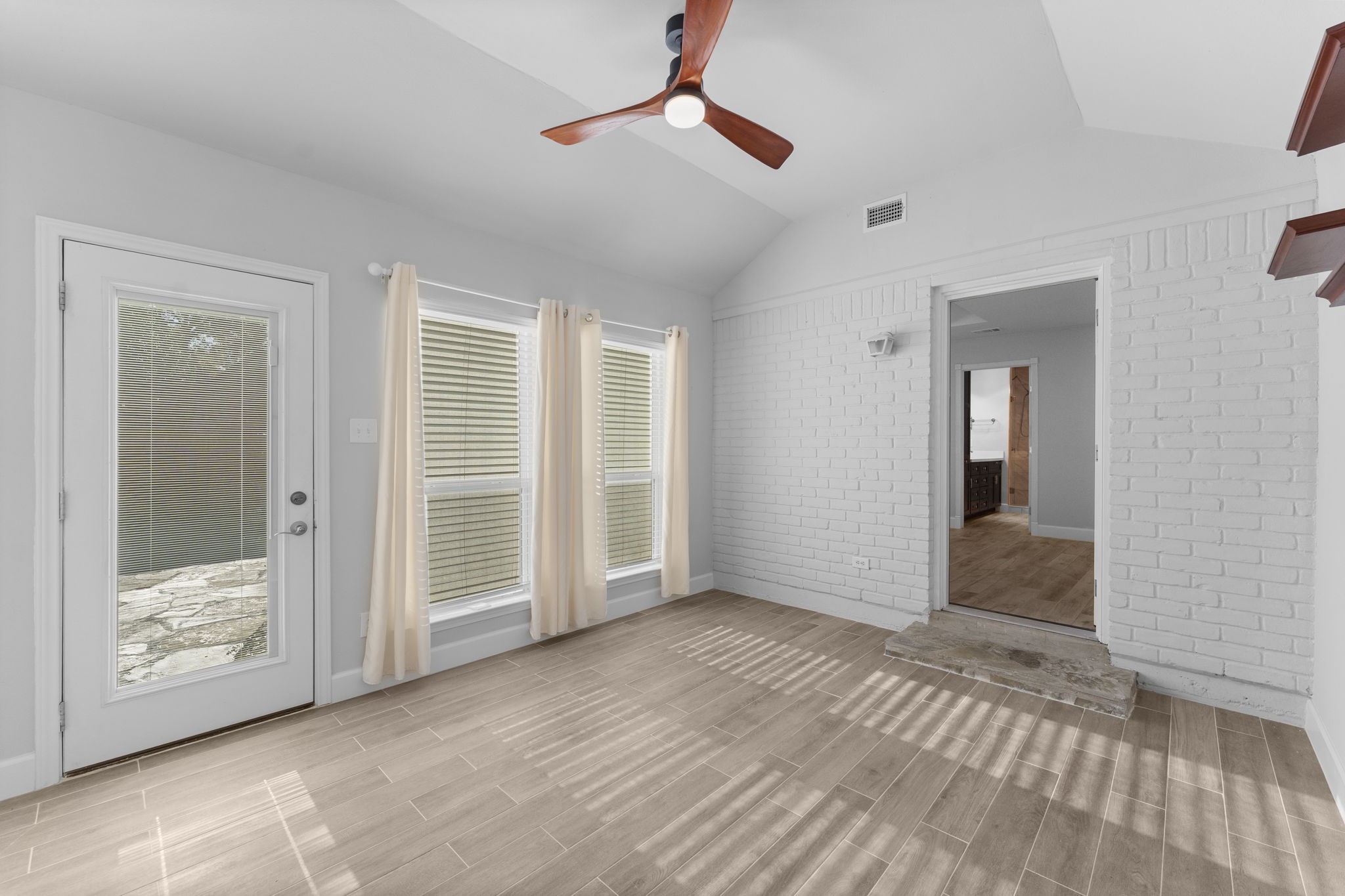 22 Shady Oak Lane Conroe, TX 77304 - Photo 35 of 44 wooden floor in an empty room with a bathroom