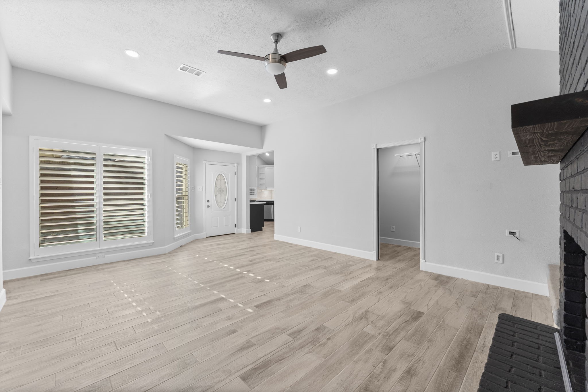 22 Shady Oak Lane Conroe, TX 77304 - Photo 10 of 44 a view of empty room with wooden floor and fan