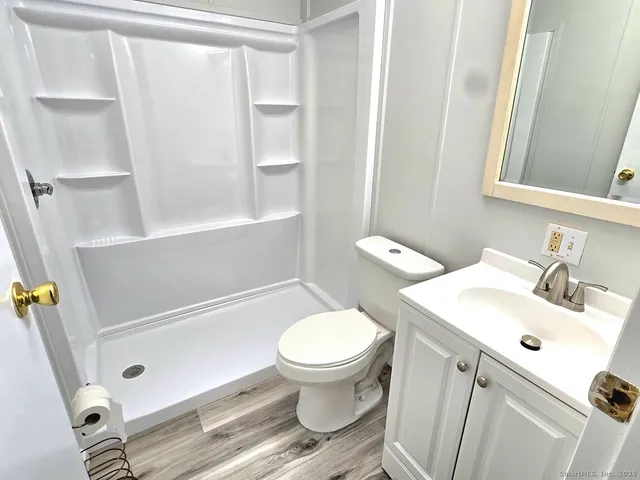 a bathroom with a sink toilet and shower