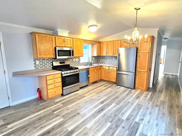 a kitchen with granite countertop a refrigerator and a stove top oven