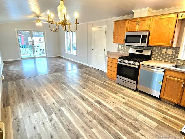 a kitchen with granite countertop a stove and a sink