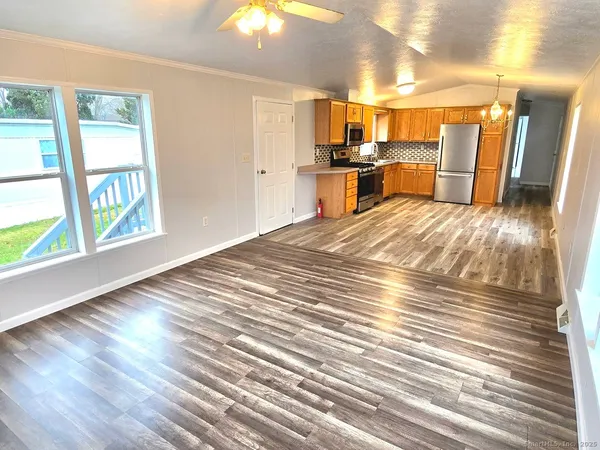 a view of a kitchen with a stove cabinets and wooden floor