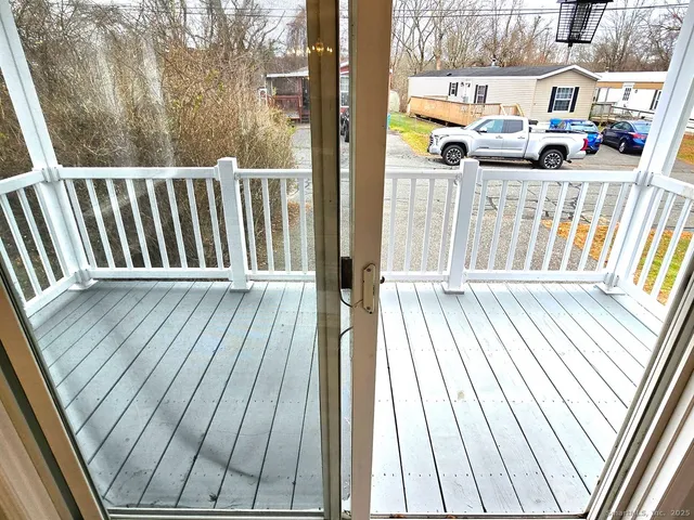 a view of a balcony with wooden floor
