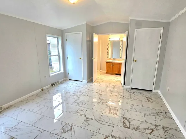 a view of a big room with windows and closet