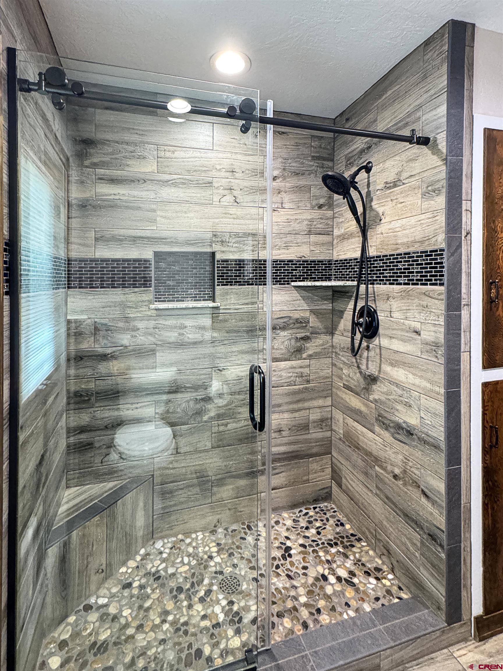 219 Edith Street Cortez, CO 81321 - Photo 18 of 29 a bathroom with a shower