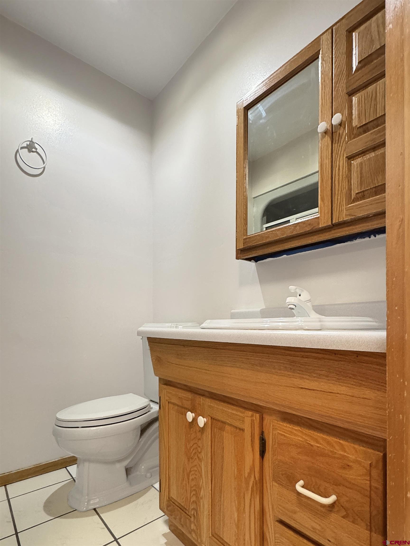 219 Edith Street Cortez, CO 81321 - Photo 25 of 29 a bathroom with a toilet a sink and mirror