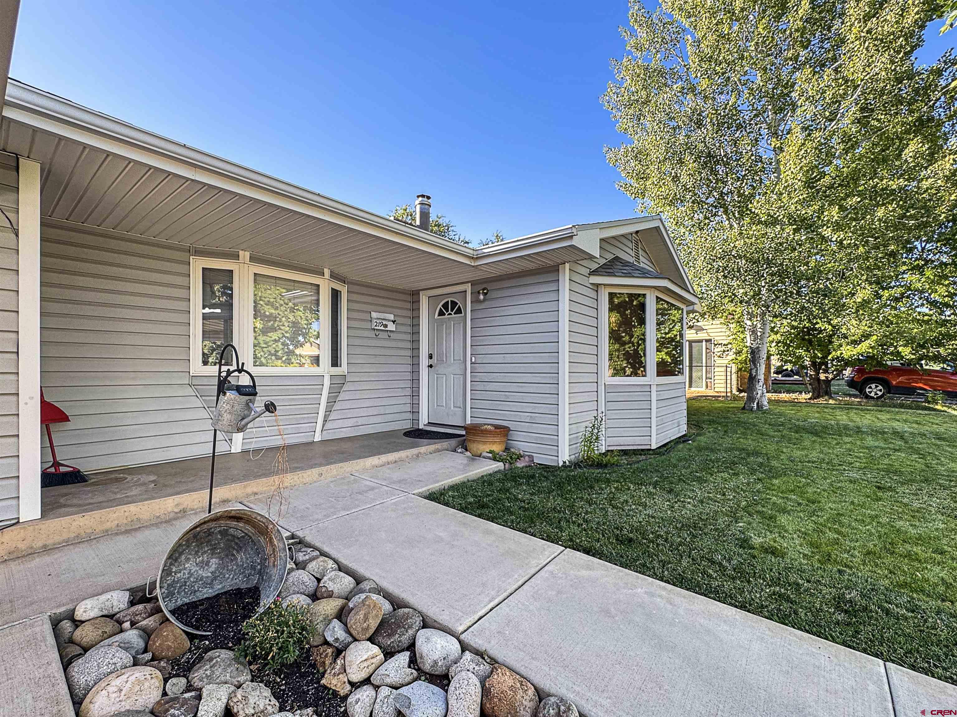 219 Edith Street Cortez, CO 81321 - Photo 3 of 29 a backyard of a house with table and chairs